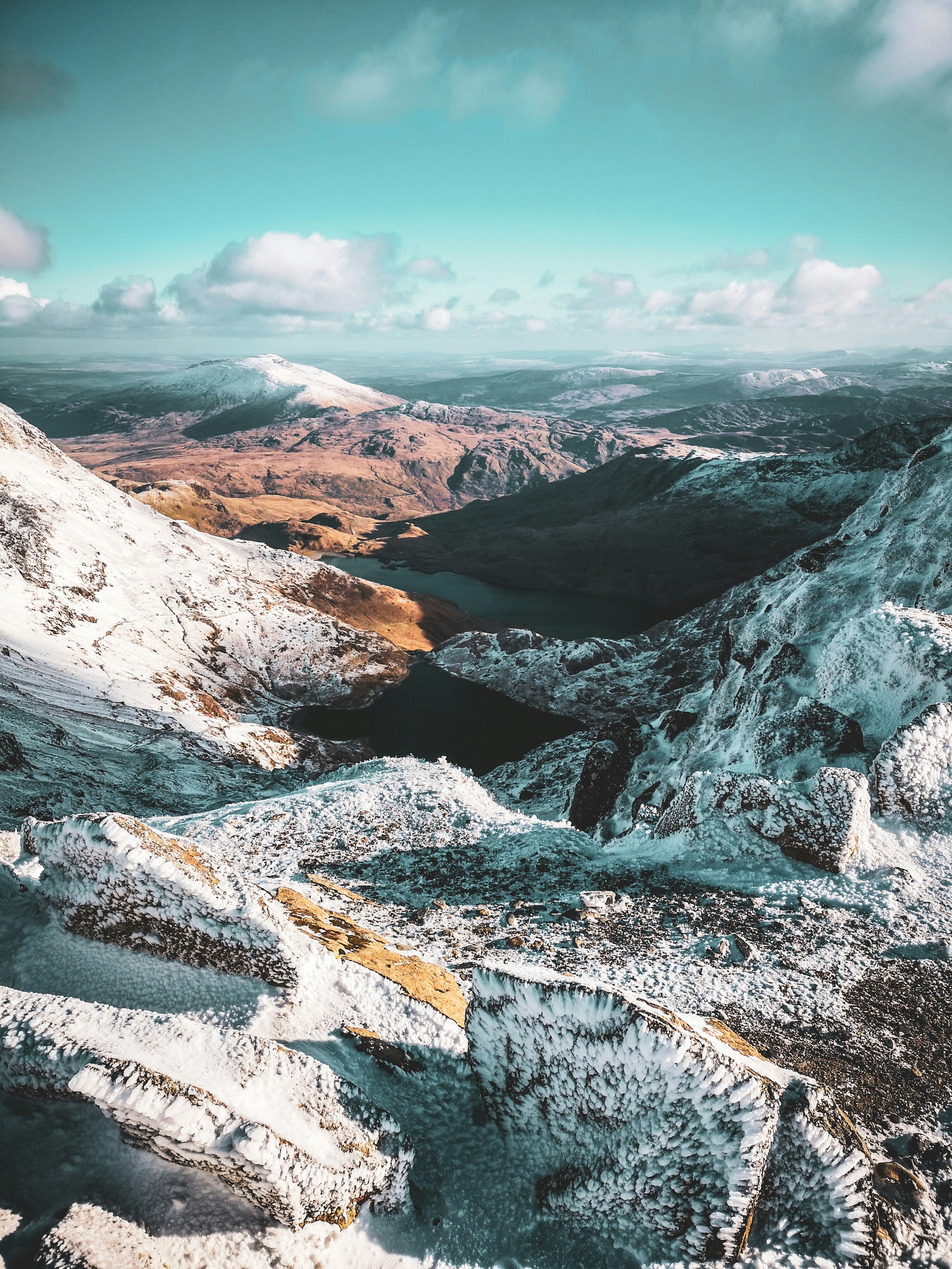 flowing snowy tipped welsh mountains